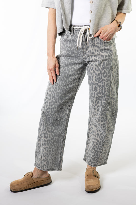 Person wearing gray leopard print pants with a white background