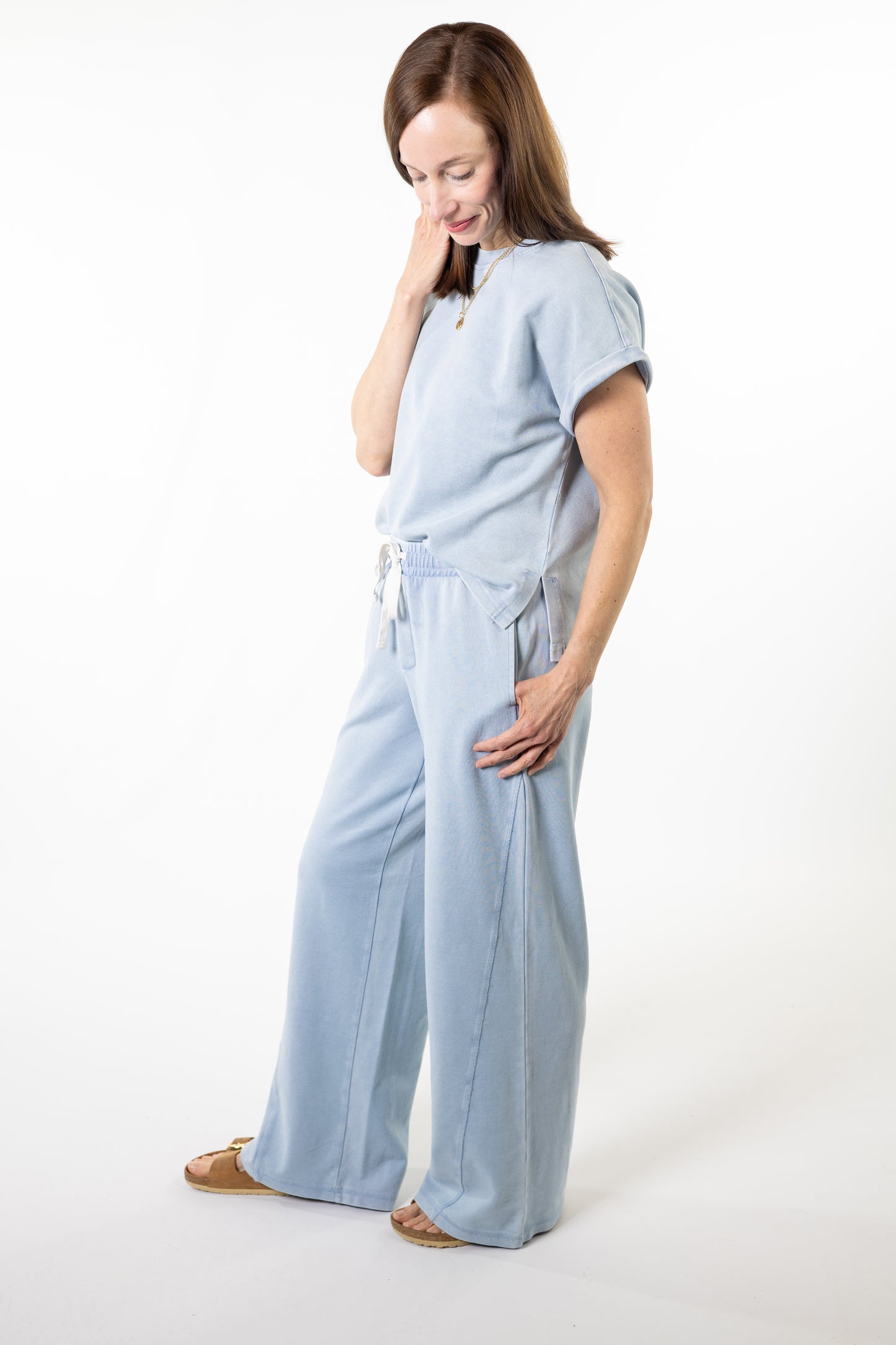Woman wearing a light blue loungewear outfit on a white background