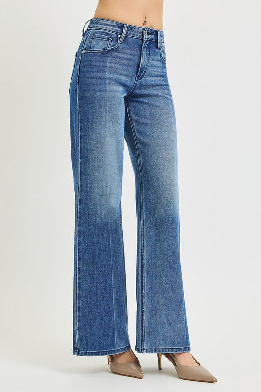 Blue jeans worn by a person on a white background
