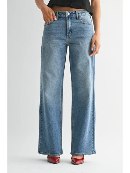 Blue jeans worn by a person on a white background