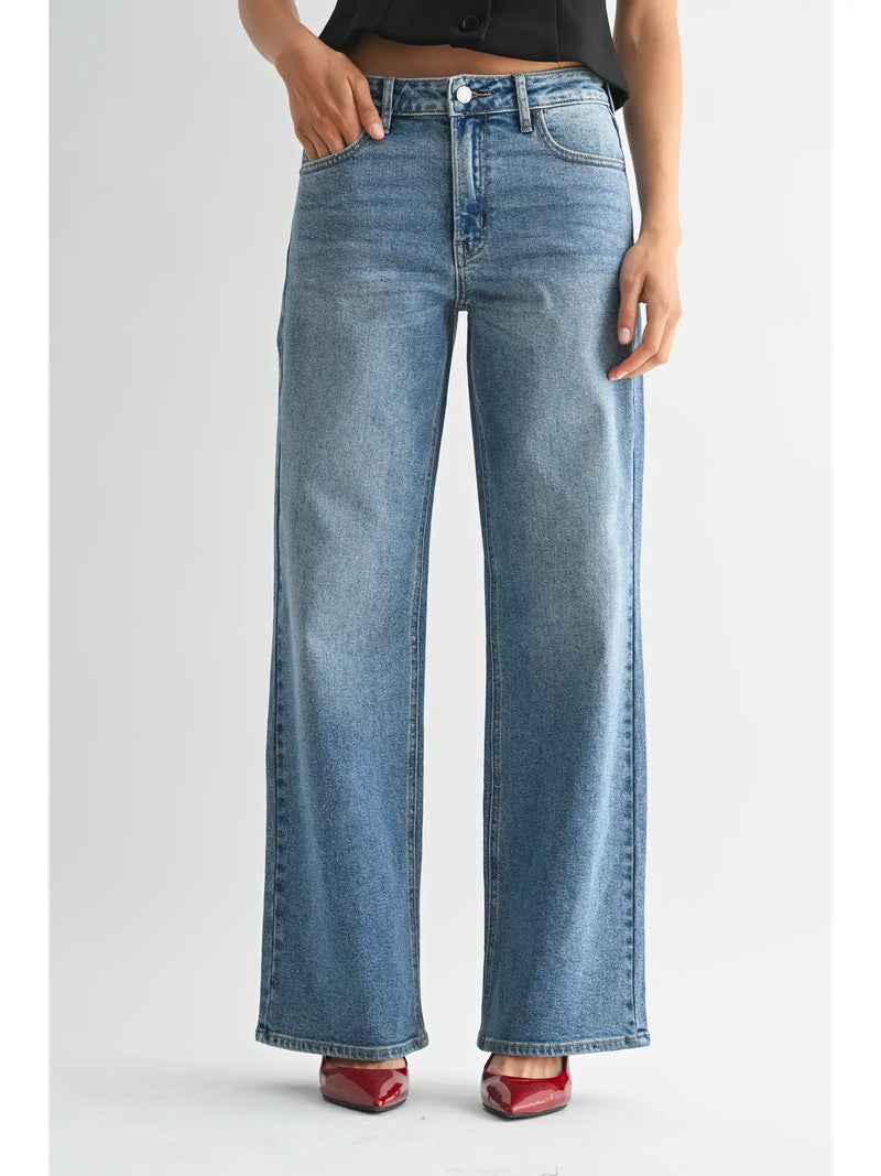 Blue jeans worn by a person on a white background