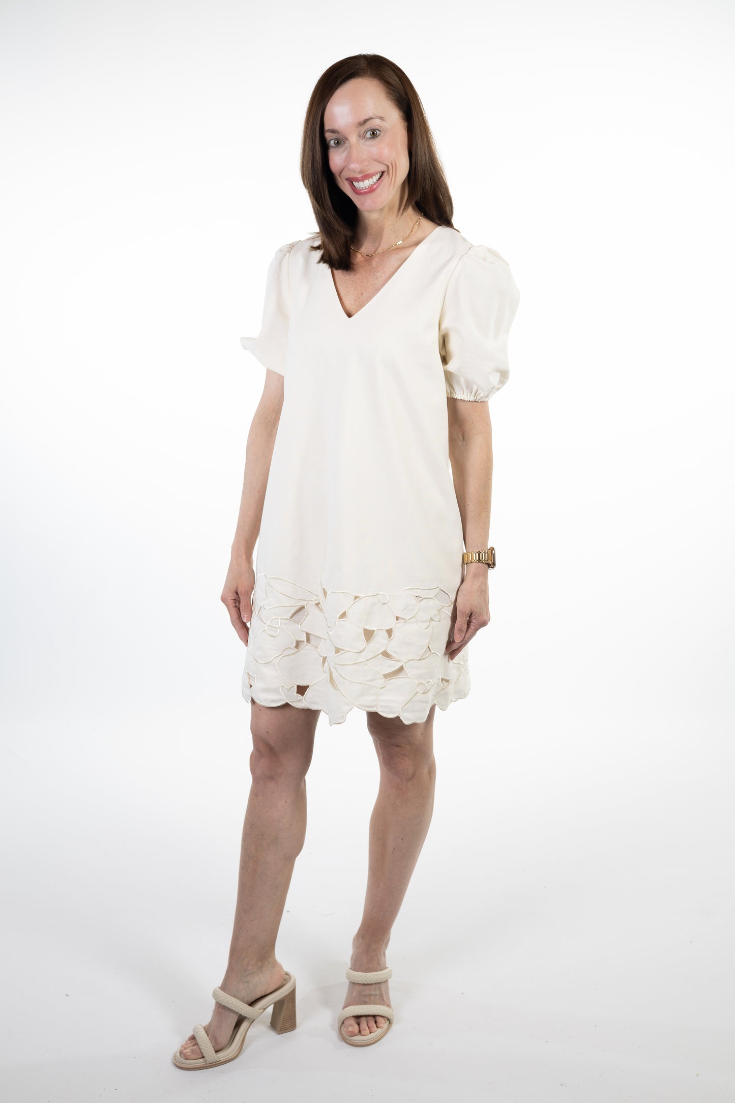 Woman wearing a white lace dress on a white background