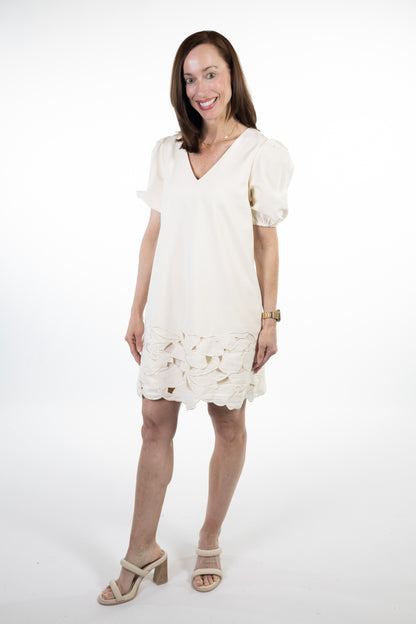 Woman wearing a white lace dress on a white background