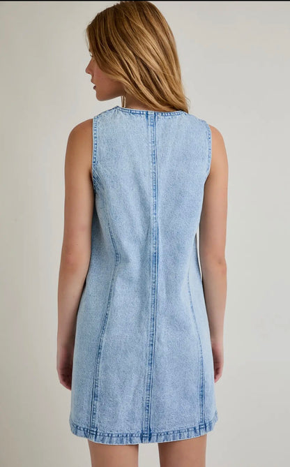 Light blue denim dress worn by a person on a plain background