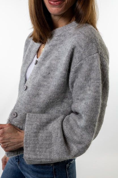 Chunky gray knit cardigan with large buttons styled casually with jeans