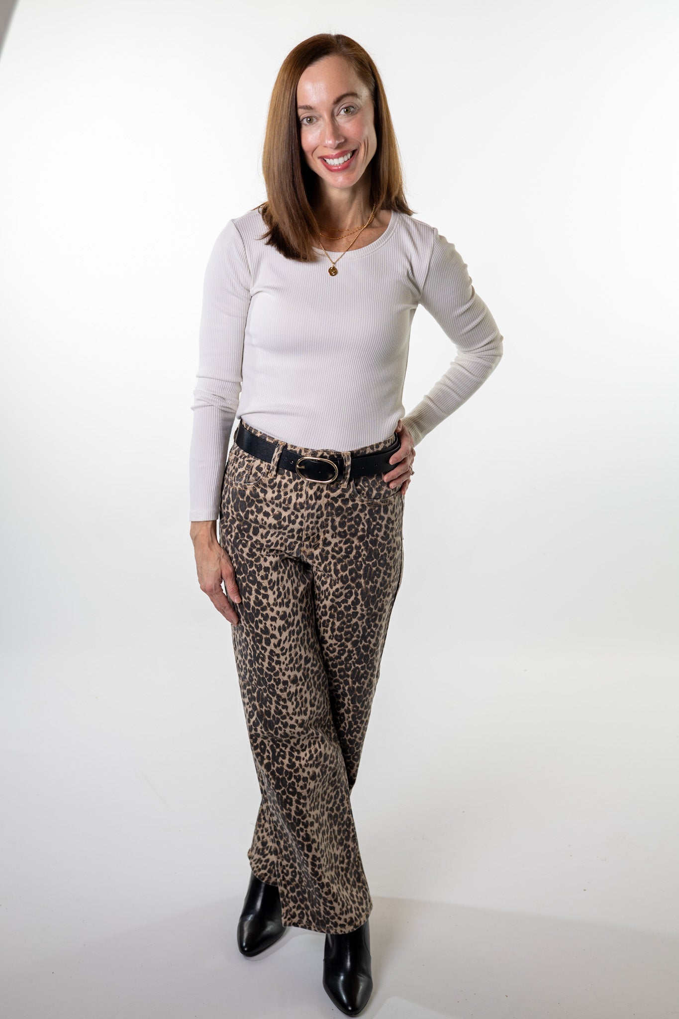 Stylish fall outfit featuring leopard print straight-leg denim pants, a soft ribbed top, and ankle boots — perfect for dinner, work, or shopping locally with Salt & Lavender Clothing in Columbus, Ohio.