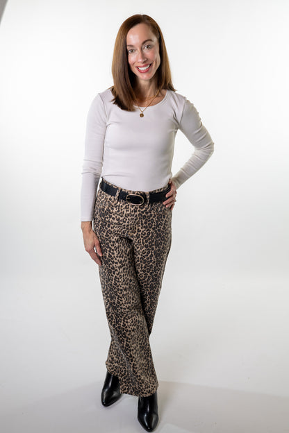 Stylish fall outfit featuring leopard print straight-leg denim pants, a soft ribbed top, and ankle boots — perfect for dinner, work, or shopping locally with Salt & Lavender Clothing in Columbus, Ohio.