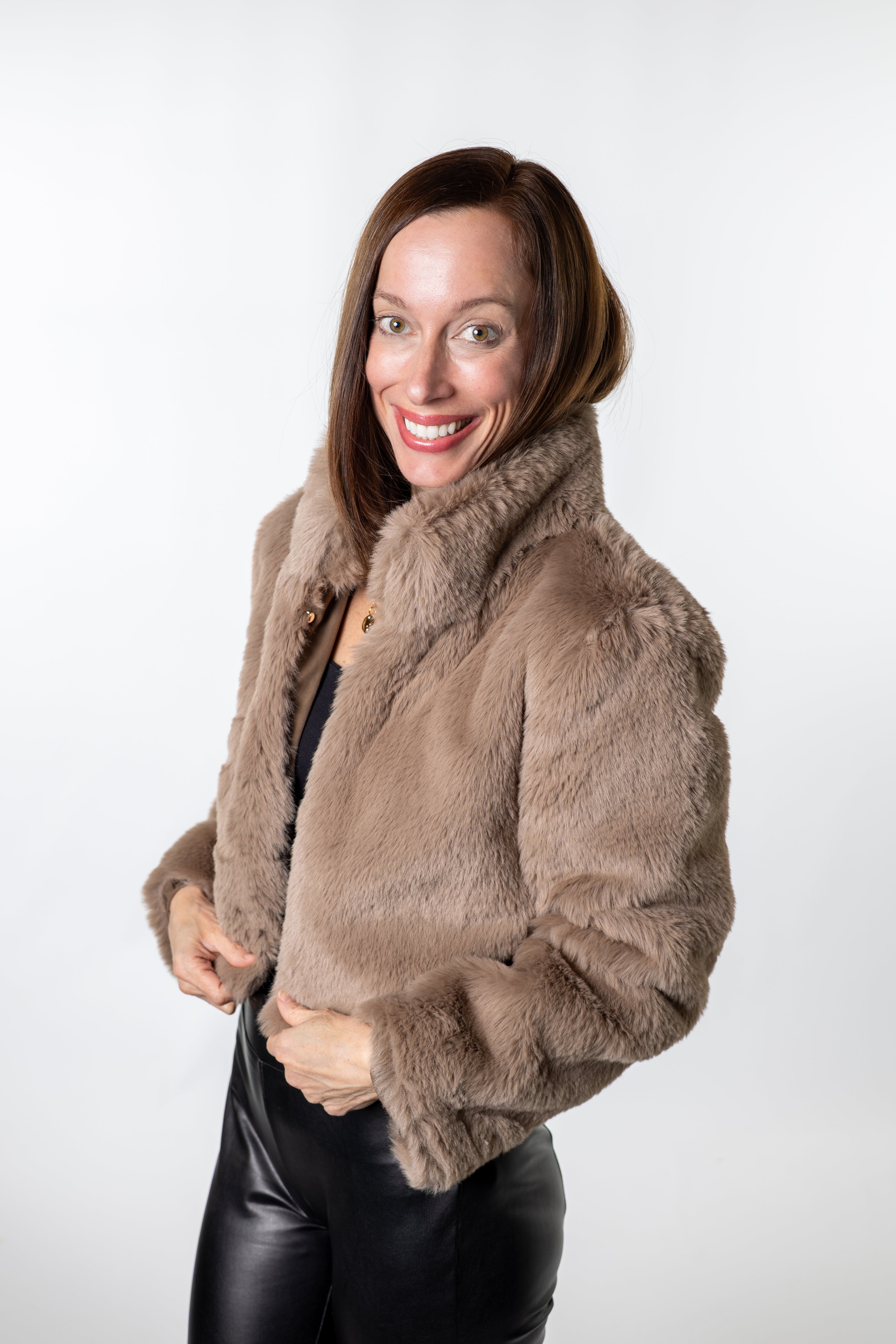Soft taupe faux-fur cropped jacket styled with sleek black pants — elegant layering piece for festive occasions and everyday wear from Salt & Lavender Clothing.