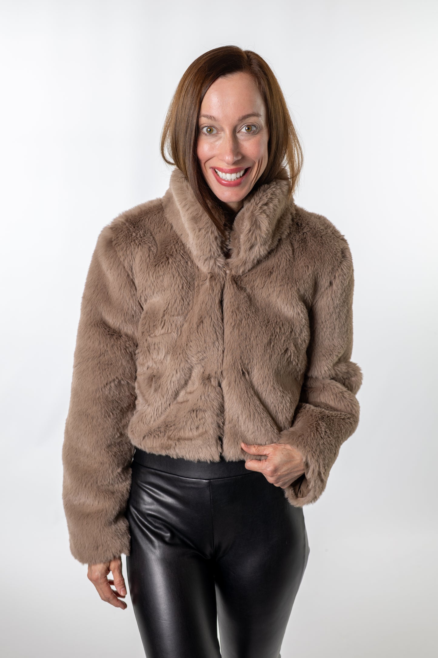 Chic winter outfit featuring a cropped taupe faux-fur jacket over a black top — effortlessly stylish holiday look from Salt & Lavender Clothing.