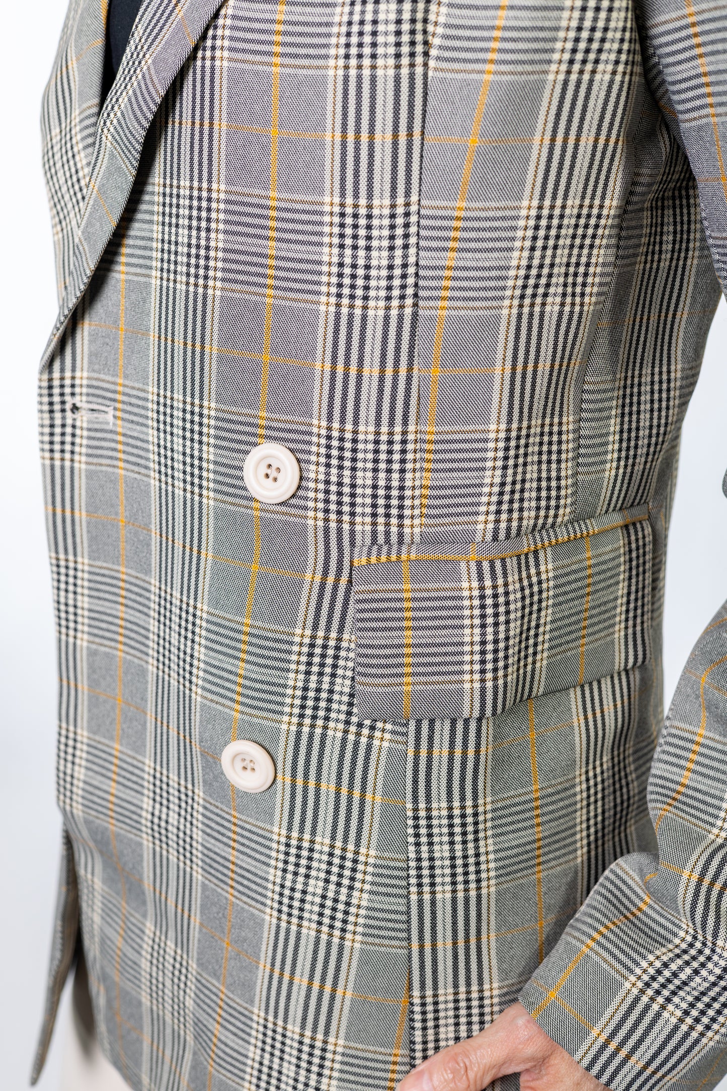 Gray brown yellow plaid suit jacket with a button on a white background