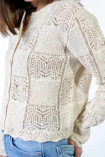Beige cream knitted sweater worn by a person on a white background