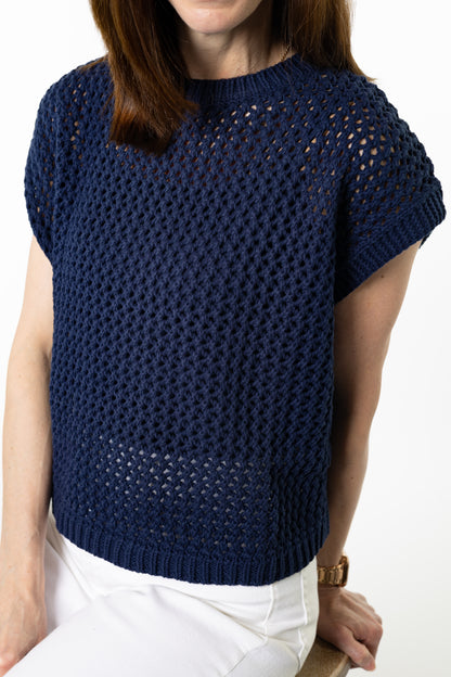 up close photo of navy blue open knit sweater worn by person
