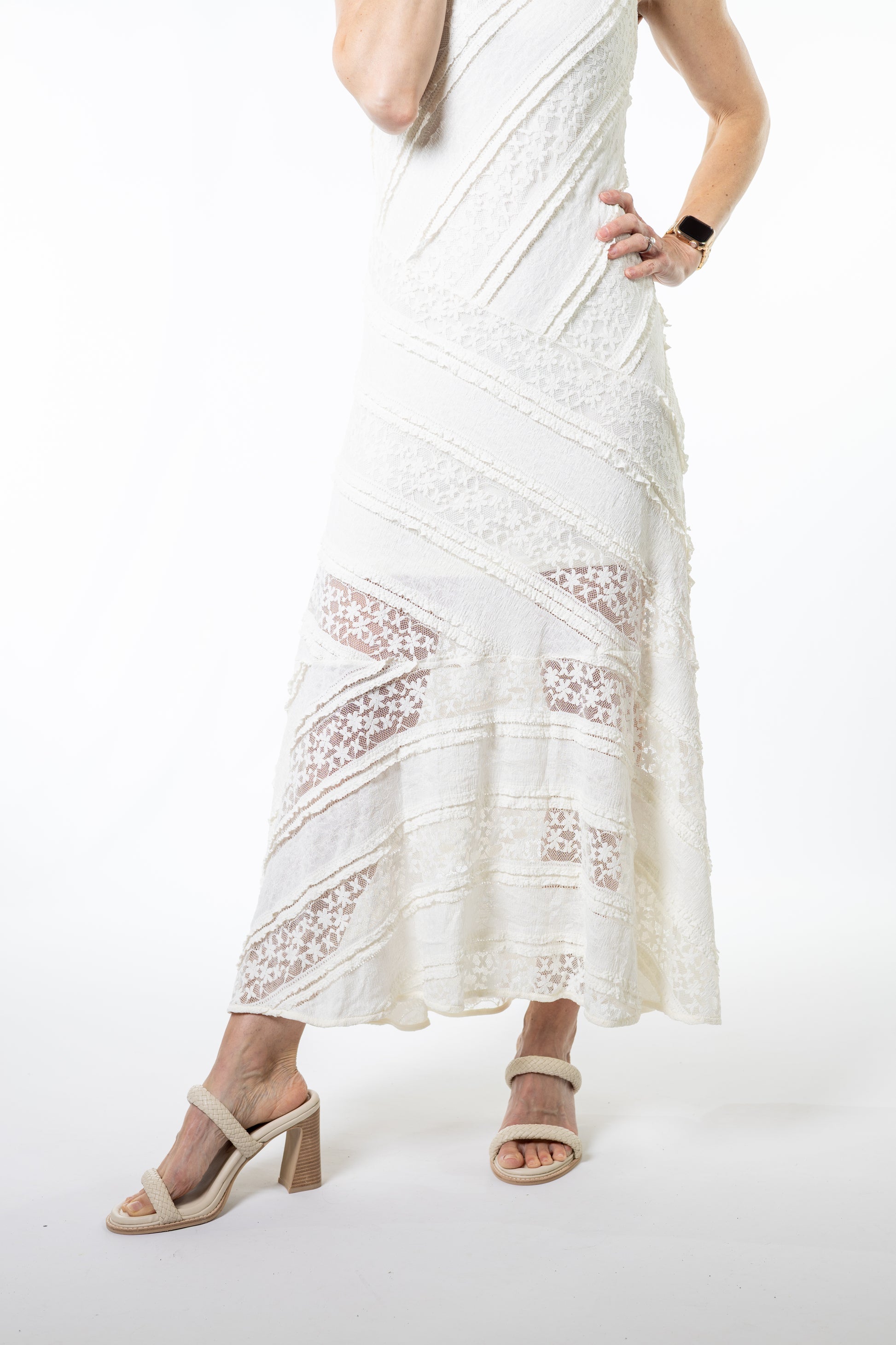 White ivory lace dress worn by a person on a white background