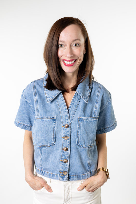 Woman wearing a denim shirt against a white background