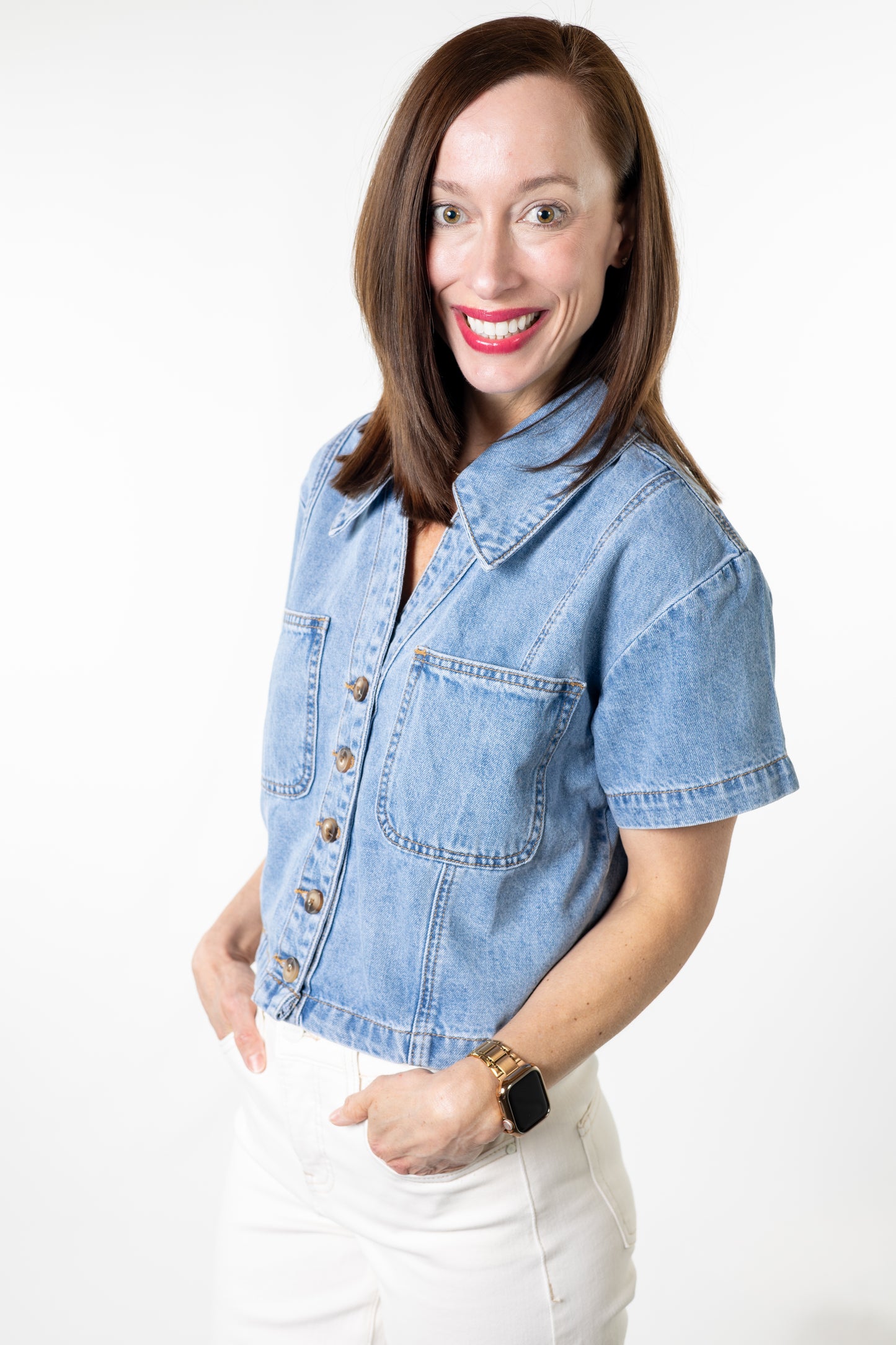Woman wearing a denim jacket on a white background