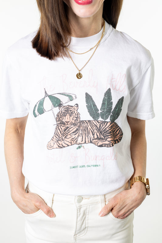 Woman wearing white shirt with tiger palm and umbrella graphic with text