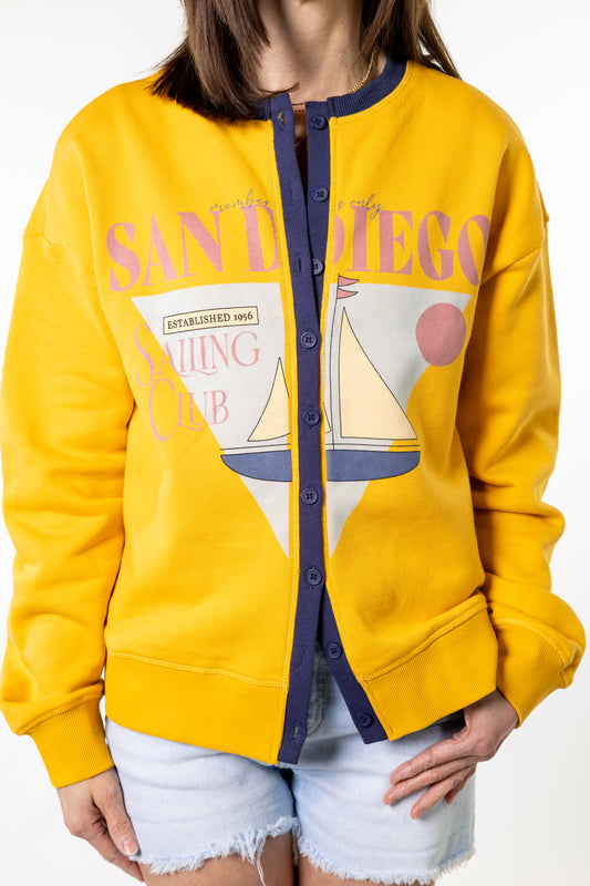 Yellow jacket with 'San Diego Sailing Club' design worn by a person on a white background