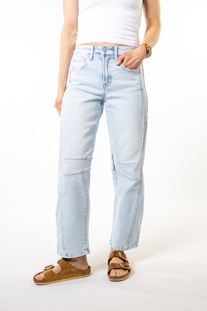 Light blue barrel jeans worn by a person on a white background