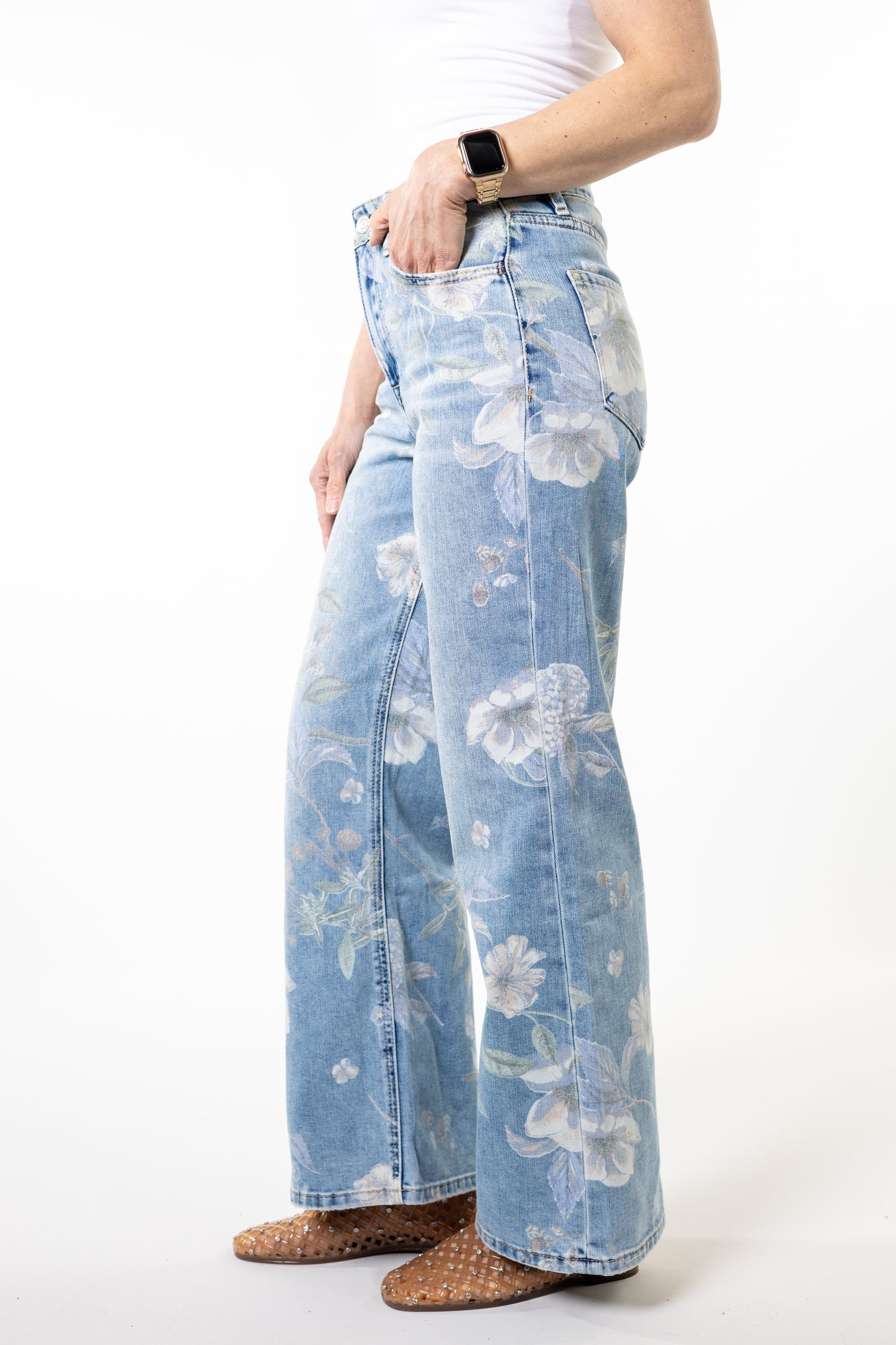 Light blue floral jeans worn by a person on a white background