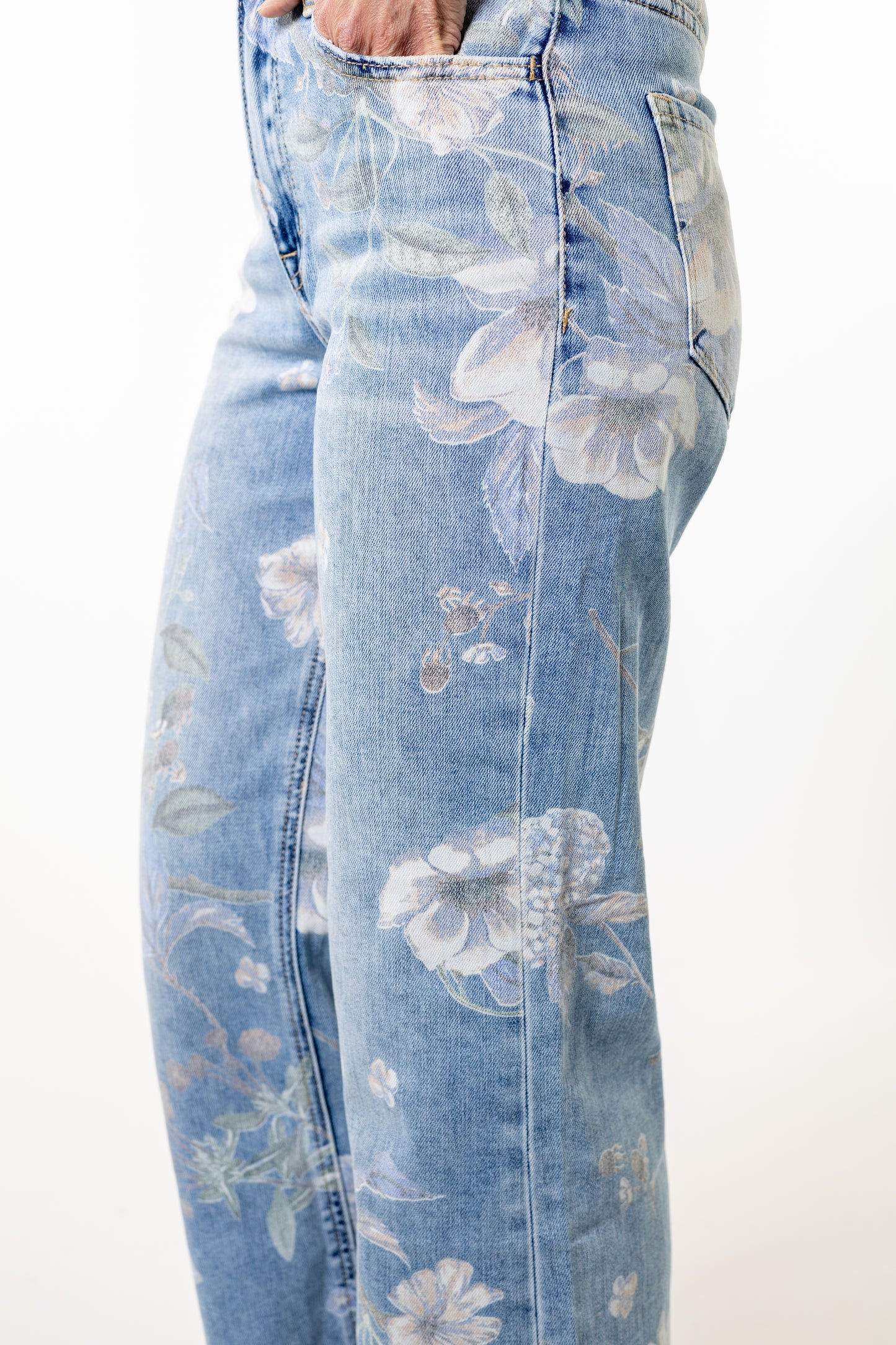 Light blue jeans with white floral patterns on a white background