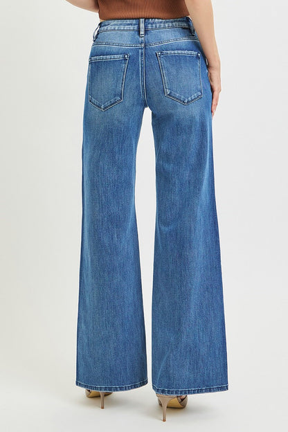 Blue jeans worn by a person on a white background