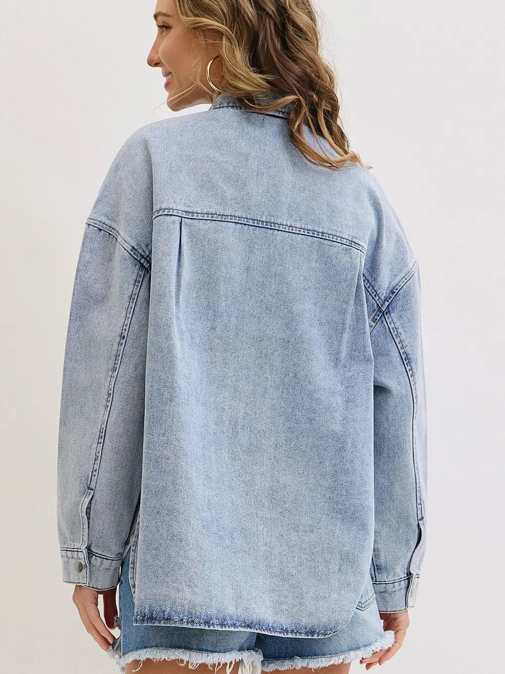 Light blue denim jacket worn by a person on a white background